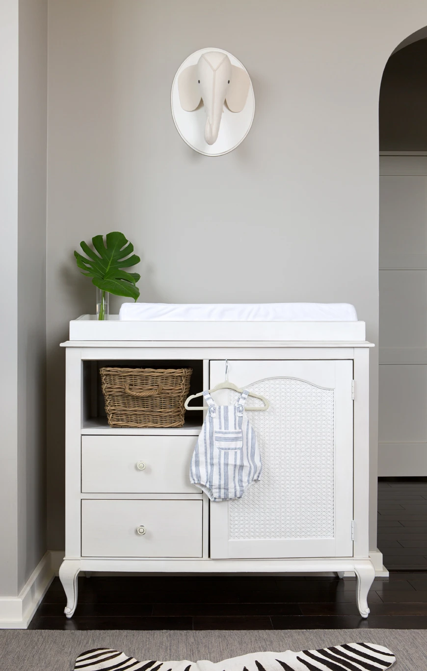 White Changing Table and Elephant Wall Decor