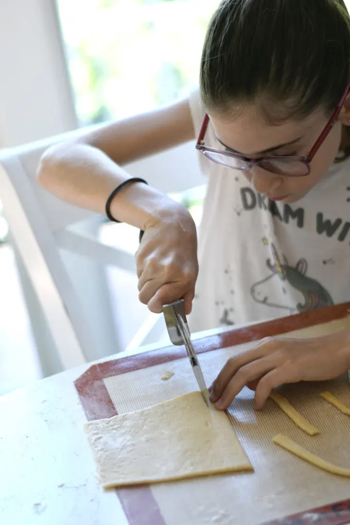 Cutting the dough into smaller sections is easier for small hands to manage